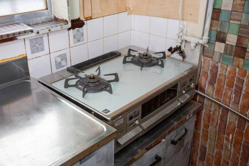 a kitchen with a stove with two burners on it at I LOVE OSAKA in Osaka