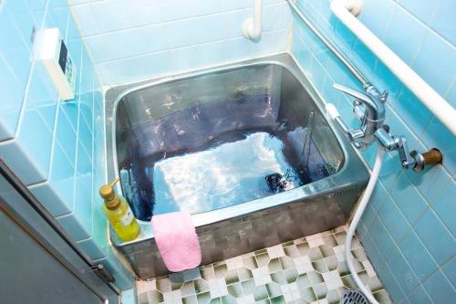 a bathroom with a bath tub with a sink at I LOVE OSAKA in Osaka