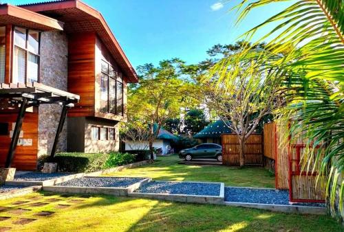 a house with a car parked in the yard at Nivana Spa & Resort in Romblon