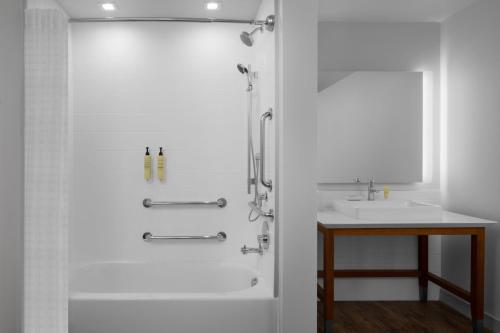 a white bathroom with a shower and a sink at Element San Antonio Riverwalk in San Antonio