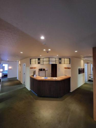 a large lobby with a bar in a building at City Villa Rアネックス in Osaka