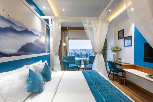德拉敦的住宿－Clarion Hotel Dehradun，配有一张床和一张书桌的酒店客房