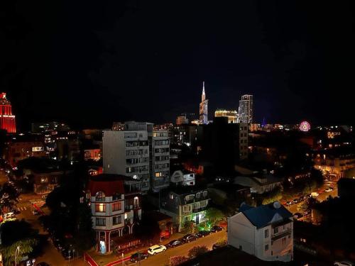 a view of a city at night with lights at LIGHT HOUSE in Batumi