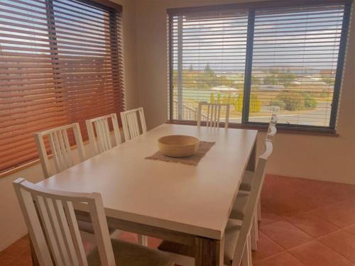 a dining room with a white table and chairs at The Oceanaire in Esperance