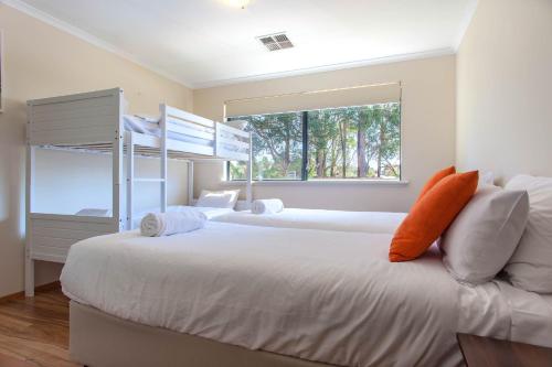 a bedroom with two bunk beds and a window at Shumadia I Private Properties in Yallingup Siding