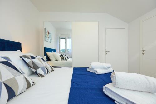 1 dormitorio con 2 camas y espejo en Mia Maria Apartment, en Cavtat