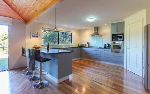 a kitchen with a island in the middle of a room at Shumadia I Private Properties in Yallingup Siding