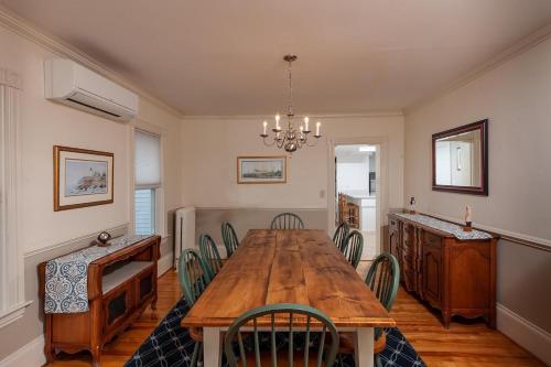 a dining room with a wooden table and chairs at Main House at One Long Beach in York Beach
