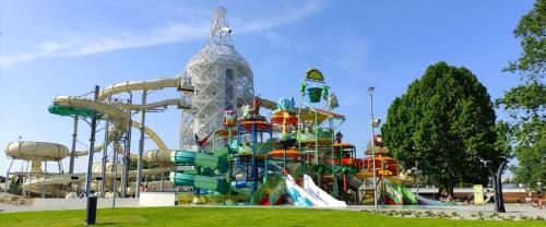 a large water park with a roller coaster at Atkacs Home in Győr