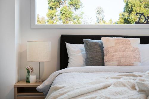 a bedroom with a bed with pillows and a window at Musk Springs in Bullarto