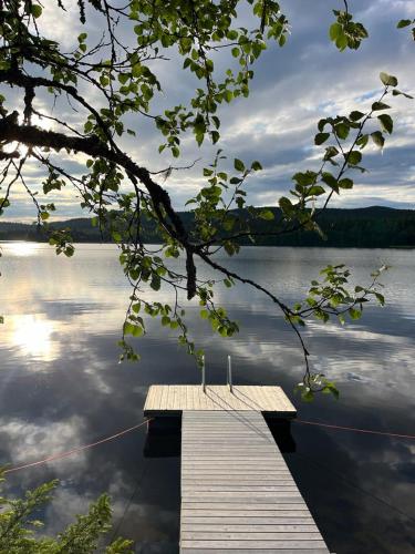a wooden dock sitting on top of a body of water at Villa Lake Ruka in Ruka