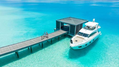 a boat on a dock in the water at The Ritz-Carlton Maldives, Fari Islands in North Male Atoll