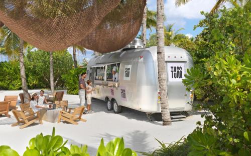 an rv parked next to a group of people at The Ritz-Carlton Maldives, Fari Islands in North Male Atoll