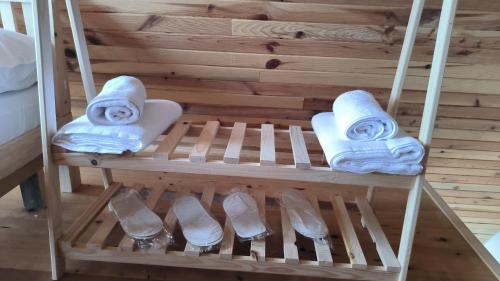 a shelf with towels and shoes on it at Neyla Suit in Arhavi