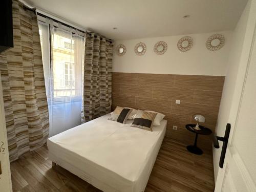a bedroom with a bed and two clocks on the wall at Appartement Gare Saint Charles in Marseille