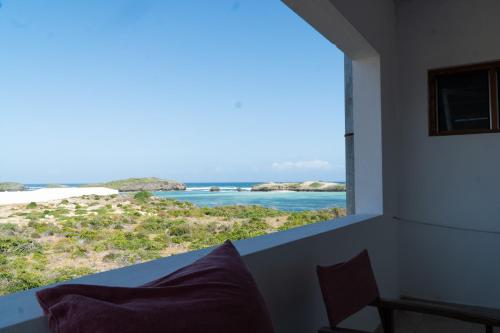 a room with a window looking out at the ocean at Visiwa Beach Resort in Watamu