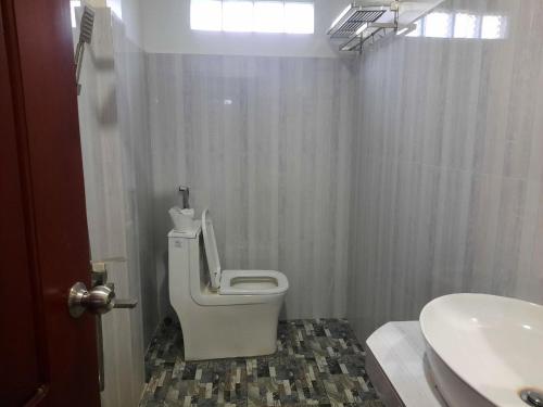 a bathroom with a toilet and a sink at Realkhom Homestay in Siem Reap