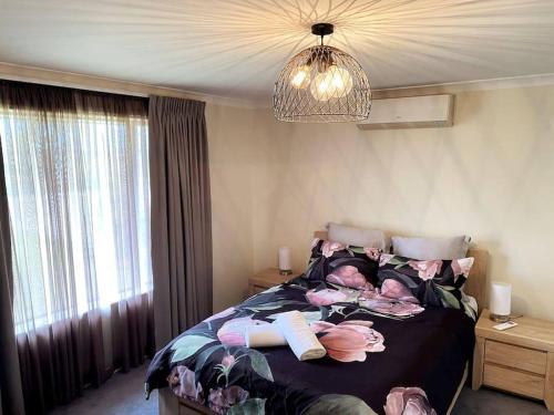 a bedroom with a bed with dolls on it at The Sundowner in Esperance