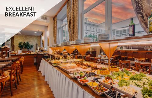 a buffet line of food at a restaurant at COLORFACTORY SPA Hotel - Czech Leading Hotels in Prague