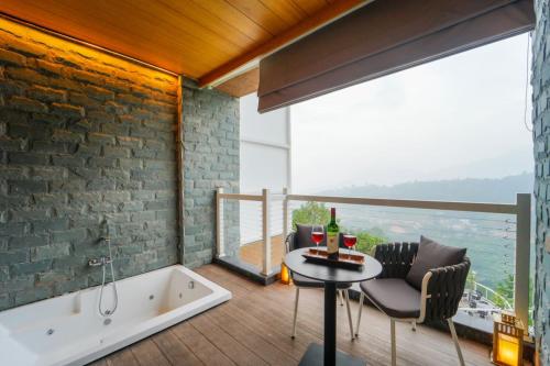 a bathroom with a bath tub and a table with a table at Anantam Resort & Spa in Kasauli