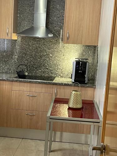 a small kitchen with a table with a toaster oven at Empordà Country House in Borrassá