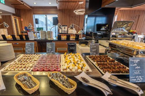 a buffet with many different types of pastries on display at Castellum Hotel Hollókő in Hollókő