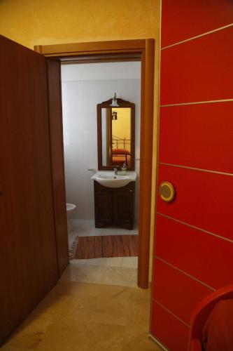 a bathroom with a sink and a mirror at Trapani Bedrooms in Trapani