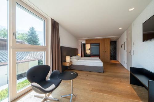 Schlafzimmer mit einem Bett, einem Schreibtisch und einem Stuhl in der Unterkunft Soley Suites - adults only in Brixen