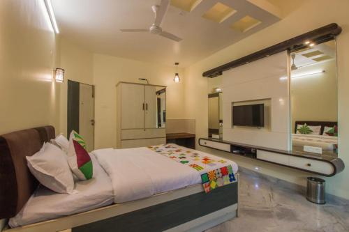 a bedroom with a bed and a large mirror at Calangute Beach Way in Calangute