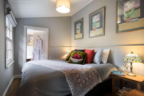 a bedroom with a bed with a basket on it at Persimmon in Clunes