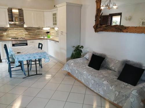 a living room with a table and a couch at Casa dal Ganzetto in Rio Marina