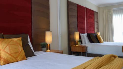 a hotel room with two beds and a window at Lakeside Suite 3 - Lake View & Spa Bath in Daylesford