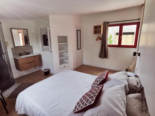 Un dormitorio con una cama con una corbata. en Mas La belle Ambroise - Chambres d'hôtes et Gîte, en Saint-Ambroix