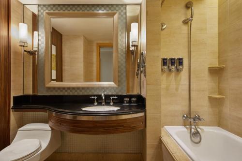 a bathroom with a sink and a toilet and a tub at Four Points by Sheraton Shenzhen in Shenzhen