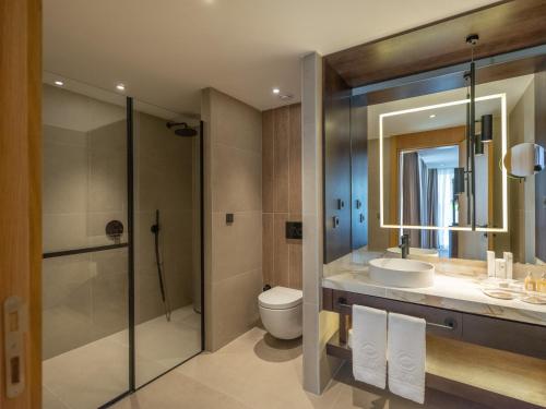 a bathroom with a toilet and a sink and a shower at Sherwood Exclusive Kemer - Kids Concept in Kemer