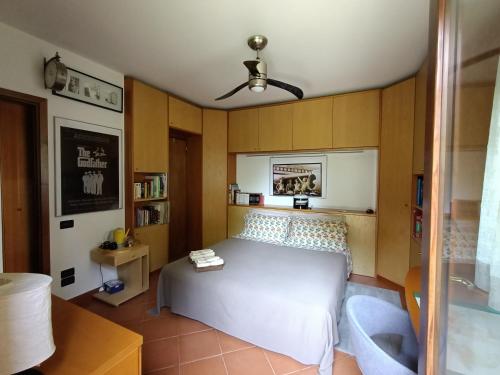 a bedroom with a large white bed and a couch at Camera nella Casa dei Tigli in Treviso