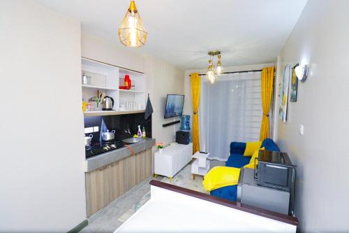 a room with a kitchen and a living room at Superb Studio Apartment in Nairobi