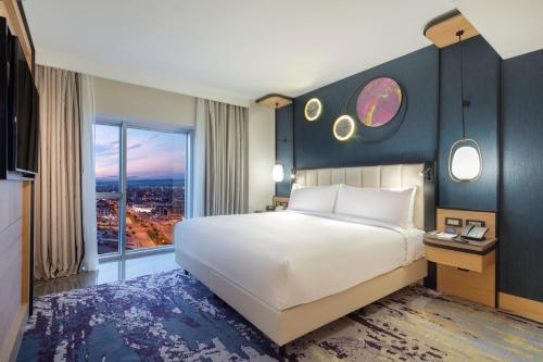 a bedroom with a large bed and a large window at Doubletree By Hilton Afyonkarahisar in Afyon
