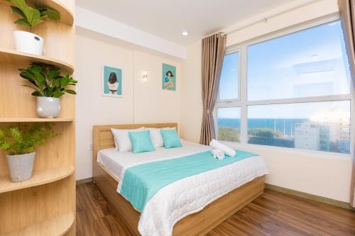 a bedroom with a bed with a large window at Vung Tau Palm Homestay 1 - Gold Sea in Vung Tau