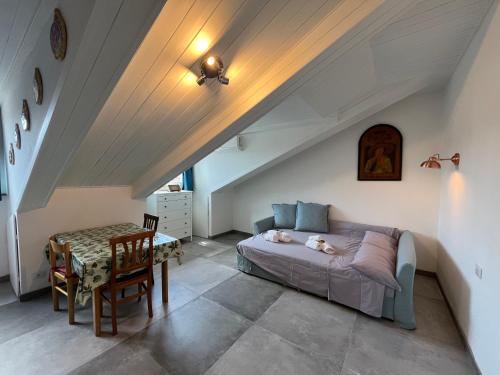 a bedroom with a bed and a table in a attic at Suite The Roof in Turin