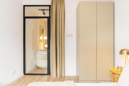 a bedroom with a mirror and a bed at Piedmont Apartments by LoftAffair in Krakow