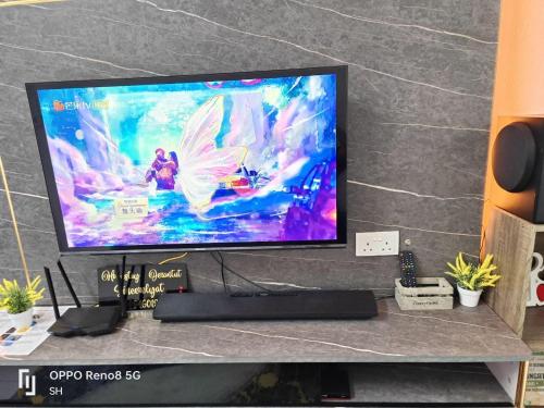 a flat screen tv sitting on top of a table at Homestay Jerantut Sincerelyat in Jerantut
