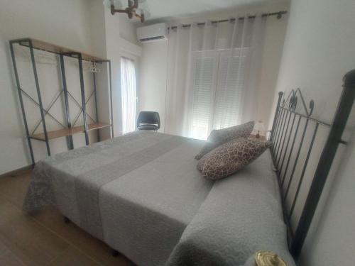 a bedroom with a large bed and a chair at Vivienda Turística Bufer Cazorla in Cazorla
