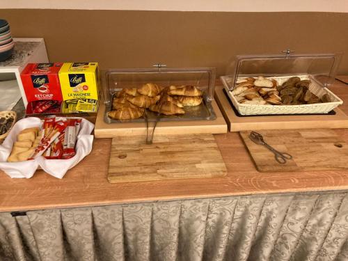 a table with some food on a counter with food at Safir Hotel Casino in Sežana