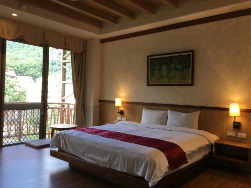 Ein Bett oder Betten in einem Zimmer der Unterkunft Ku Kuan Resort Hotel