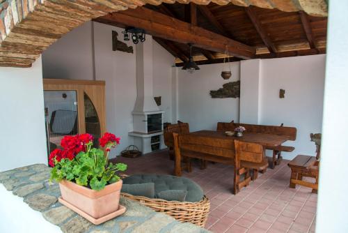 a living room with a table and a vase of red flowers at Wellness chalupa Podolí in Mladá Vožice