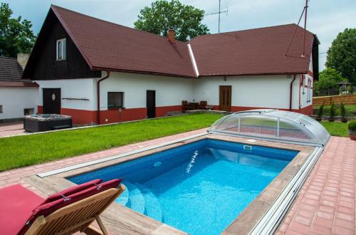 a swimming pool in the backyard of a house at Wellness chalupa Podolí in Mladá Vožice