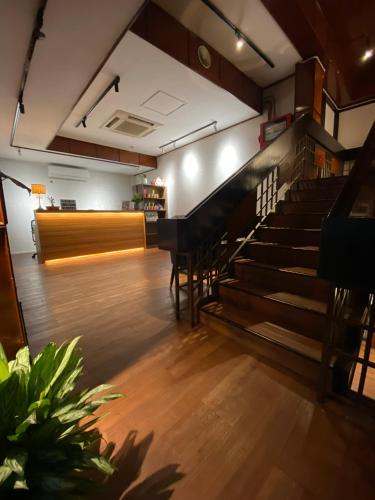 an empty room with stairs and tables and chairs at CU Boutique Hotel in Kota Kinabalu