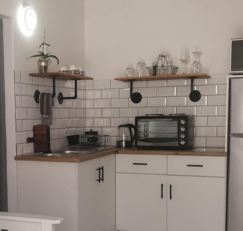 a kitchen with white cabinets and a counter top at Pet Friendly Bartholomeus Diaz beach in Mossel Bay
