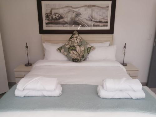 a bedroom with a bed with towels on it at Pet Friendly Bartholomeus Diaz beach in Mossel Bay